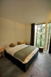 a bedroom with a large bed and a large window at Varesello 20 in Brunate