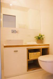 a bathroom with a sink and a toilet and a mirror at Varesello 20 in Brunate +66 photos