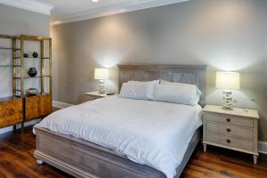 a bedroom with a large bed with two night stands at Liberty Street Redbrick Town and Carriage House in Savannah