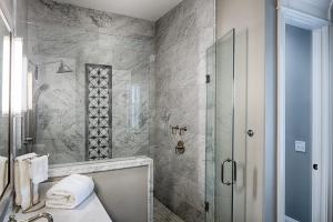 a bathroom with a shower and a sink at Liberty Street Redbrick Town and Carriage House in Savannah +50 photos