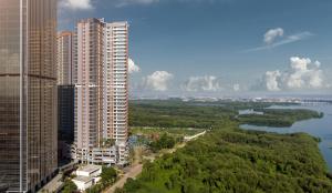 a view of a city with tall buildings and a river at Oakwood Apartments PIK Jakarta in Jakarta
