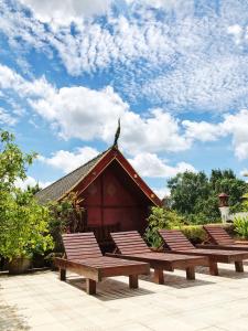a group of benches in front of a building at S.K.House 2 in Chiang Mai