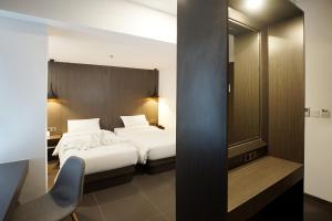 
A bed or beds in a room at Malioboro Prime Hotel
