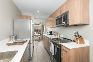 a kitchen with wooden cabinets and a refrigerator at Matterhorn Inn in Sedona
