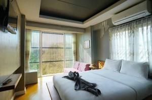 Un pat sau paturi într-o cameră la L'NER chiang mai