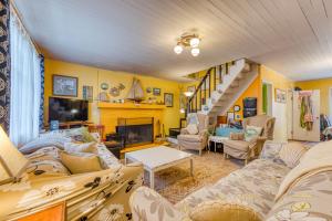 a living room with couches and a staircase at Cottage by the Sea in Rockaway Beach