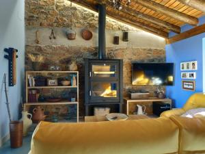 a living room with a couch and a fireplace at Casa Rural Madre del Agua. Finca El Robledillo in Monesterio