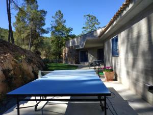 a blue ping pong table sitting on a patio at Casa Rural Madre del Agua. Finca El Robledillo in Monesterio