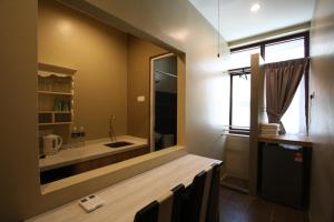 a bathroom with a large mirror and a sink at Shamrock Greenhill in Ipoh