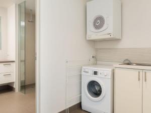 a white laundry room with a washer and dryer at Waikiki Dream in Smiths Beach