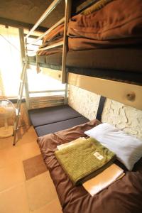 Ліжко або ліжка в номері Taketomijima Guesthouse and je Taime