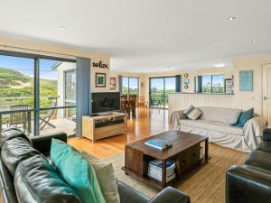 a living room with a couch and a table at Adnajur in Surf Beach