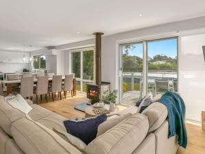 a living room with a couch and a fireplace at All Decked Out in Smiths Beach