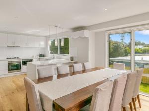 a kitchen and dining room with a table and chairs at All Decked Out in Smiths Beach