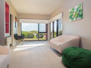 a living room with a couch and chairs and a balcony at Amazing Views in Surf Beach