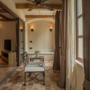 a room with a chair and a table and a window at Toscana Valley Town Square Suites in Mu Si +80 photos