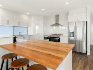 a kitchen with a wooden counter top in a room at Swan Bay Lookout in Surf Beach