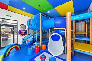 a childs room with a superhero themed play room at Great Northern Hotel in Kempsey