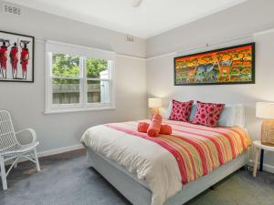 a bedroom with a bed with a teddy bear on it at Strathallan in Cowes