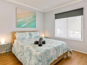 a bedroom with a bed with a teddy bear on it at Beachy Keen in Cowes