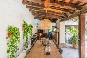a dining room with a wooden table and a ceiling at Villa Can Duarry - Barcelona Country House 1 in Premia de Dalt