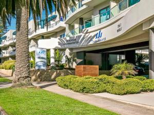 a building with a palm tree in front of it at Saltwater Haven in Cowes