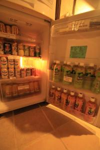 an open refrigerator filled with lots of drinks at Taketomijima Guesthouse and je Taime in Taketomi