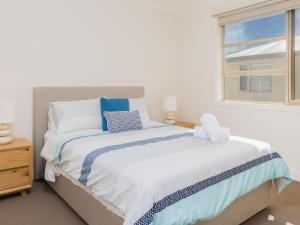 a bedroom with a large bed with a window at Retreat on Albert in Cowes
