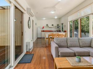 a living room with a couch and a table at Resort Haven in Cowes