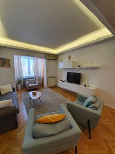 a living room with two couches and a tv at Ultracentral Apartments in Bucharest