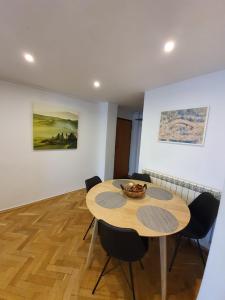 a dining room with a wooden table and chairs at Ultracentral Apartments in Bucharest