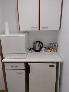 a kitchen counter with a coffee maker and a microwave at Ultracentral Apartments in Bucharest