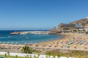 plaża z mnóstwem ludzi i ocean w obiekcie Apartamento Happy Dreamer w mieście Puerto Rico de Gran Canaria