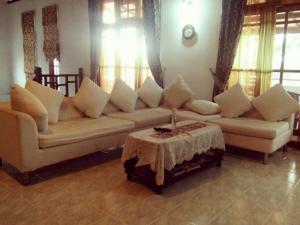 a living room with a couch and a table at Tea Hills Bungalow in Hatton