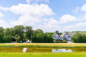 a row of houses next to a lake at Prins Hendrik Texel in Oost