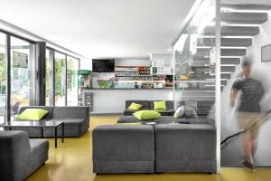 a person walking through a living room with a couch at Youth Hostel Trbovlje in Trbovlje
