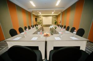 une salle de conférence avec une grande table et des chaises dans l'établissement The Bountie Hotel and Convention Centre Sukabumi, à Sukabumi