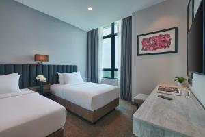 A bed or beds in a room at Stellar Putrajaya Hotel ( Official Page )