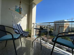 a balcony with chairs and a table and a view of a city at Rivera Apartments - Premium Accomodation in Iaşi
