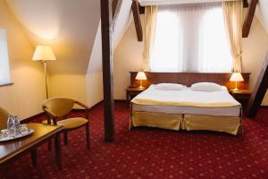 Postel nebo postele na pokoji v ubytování Hotel Jakub Sobieski