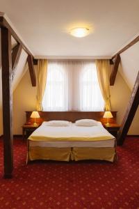 Posteľ alebo postele v izbe v ubytovaní Hotel Jakub Sobieski