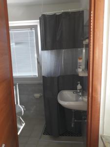 a bathroom with a sink and a shower curtain at Hotel La Torretta in Foligno