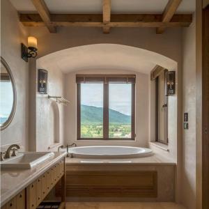 baño grande con bañera y ventana en Toscana Town Square Suites en Mu Si