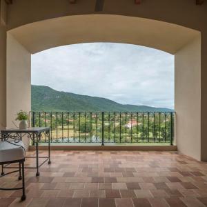 a room with a large window with a view of a mountain at Toscana Town Square Suites in Mu Si