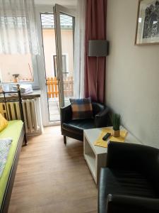 a living room with a couch and a chair at Pension Glückauf in Kurort Oberwiesenthal