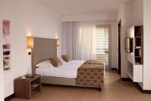 Un pat sau paturi într-o cameră la Residence Hotel Parioli