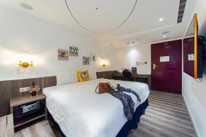 Ένα ή περισσότερα κρεβάτια σε δωμάτιο στο Norway Forest Travel hotel 1 Taichung