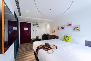 Ένα ή περισσότερα κρεβάτια σε δωμάτιο στο Norway Forest Travel hotel 1 Taichung