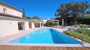 a swimming pool in the backyard of a villa at Villa Alinea in Sainte-Maxime