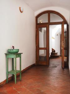 a room with a door and a table with a sink at Penzion Kamenne Slunce in Telč